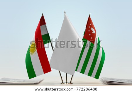 Flags of Kurdistan and Abkhazia with a white flag in the middle