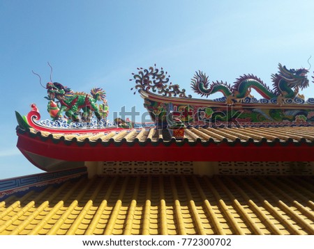 Dragon statue on the roof.