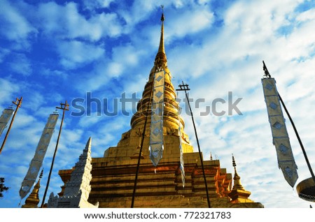 Relic of the Buddha. Golden Pagoda Blue Sky and White Cloud. Northern Tradition Thai Temple. Golden and Blue Background. 