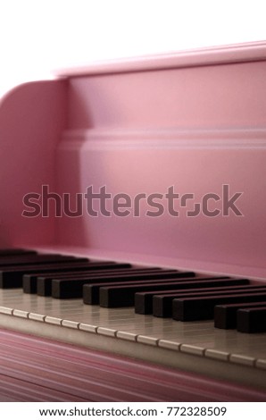 Close-up of the keyboard of a pink piano. Set of white and black buttons