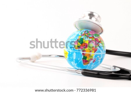 Globe and stethoscope over white background. Save the world