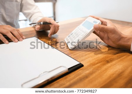 Real Estate agent showing a contract signature with customer to making a valuation deal