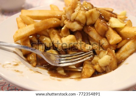 Canadian Quebec Poutine stock photograph with a fork in it 