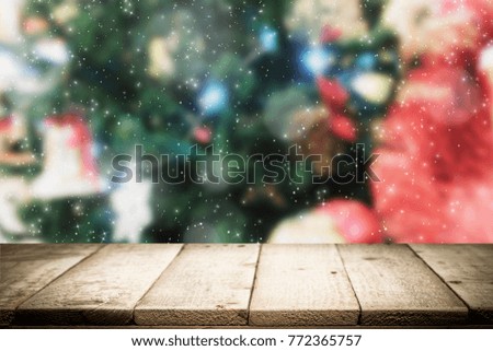 Wood table top on Christmas decorataion tree background used for montage or display the products