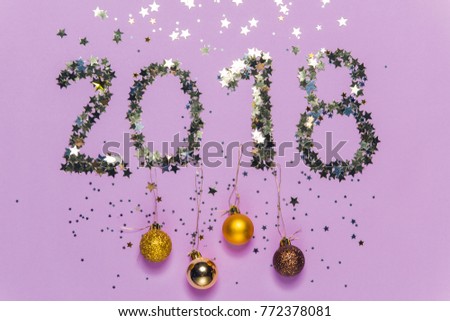 2018 made of gold and silver confetti in the shape of stars with christmas decoration