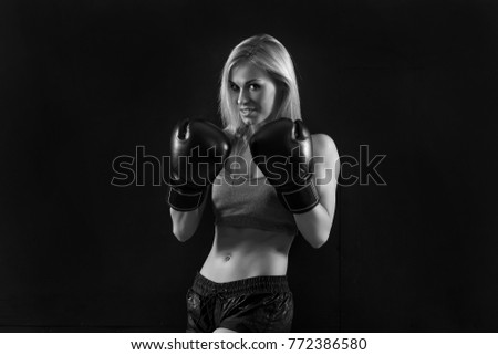 young beautiful woman with the boxing gloves