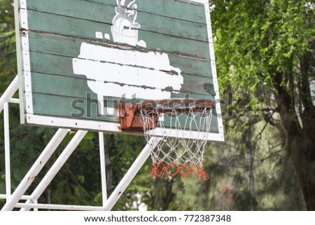 old basketball hoop and red and white nylon in park outdoor
