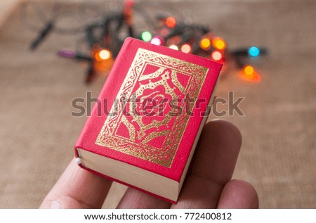 Islamic Holy Book Quran with lights behind