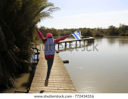 girl jumping with Israeli flag