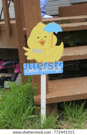 A shot of an Easter Duck holding an Umbrella that is bright an colorful on an Easter Day. In Sterling Kansas.