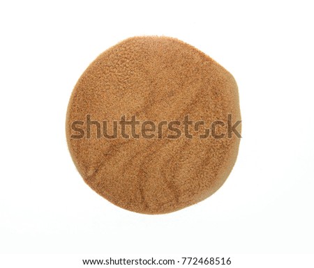 Fine desert sand collected on white background. An abstract circular shape made with an earth element- sand.