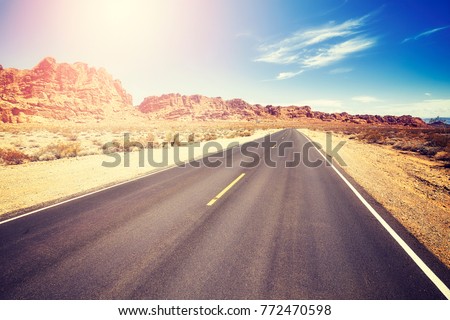 Vintage toned picture of a desert road, travel concept, Valley of Fire State Park, Nevada, USA.