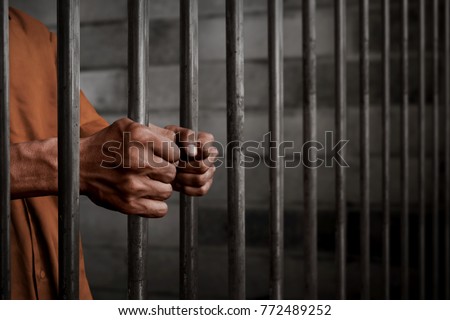 Man in prison Royalty-Free Stock Photo #772489252