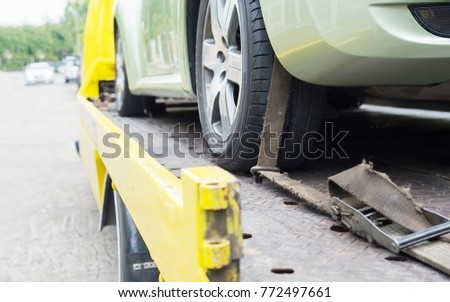 car transporter breakdown lorry during working using locked belt transport other green car for repairing at car center in a bangkok city thailand Royalty-Free Stock Photo #772497661