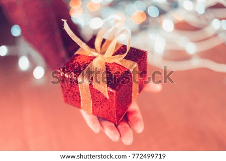 Female hand with Christmas gift box, selective focus
