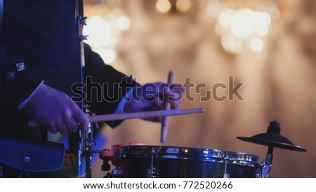 Drum performer plays drumstick at the concert
