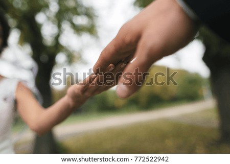 the hand of the guy touches the girl's hand with a close up