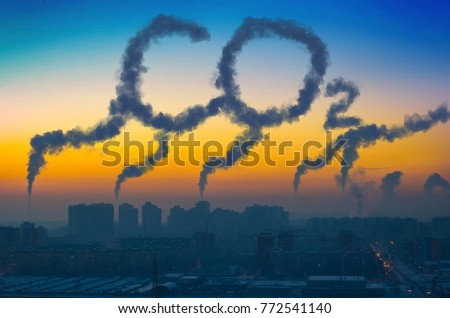 Evening view of the industrial landscape of the city with smoke emissions from chimneys at sunset CO2 Royalty-Free Stock Photo #772541140