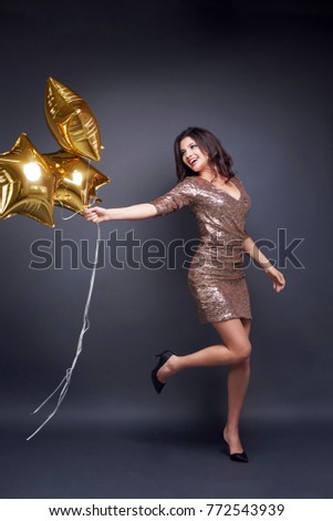 Cheerful woman with balloon at studio shot 