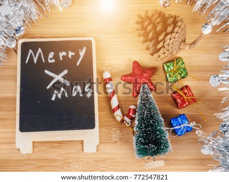 Decorations and symbols of christmas placed on wooden table.