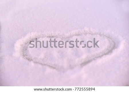 Drawing heart. White snow. Winter.