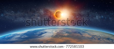 Solar Eclipse  in front of the Milky Way galaxy "Elements of this image furnished by NASA "