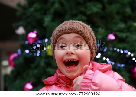 Young girl on background of the Christmas tree