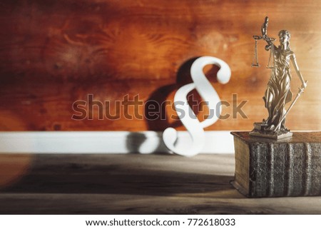 Statue of Justice with Paragraph icon in a lawyer office. law, advice and justice concept image