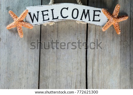 Marine theme. Wooden background. Sea stars. Welcome board. Place for text.