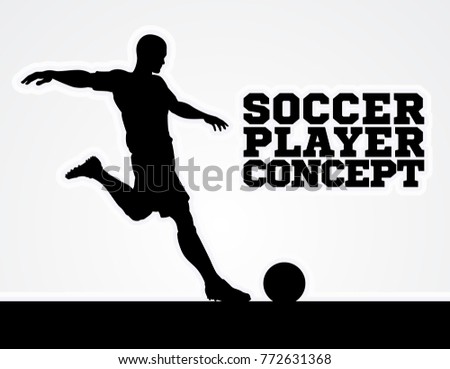 A silhouette of a soccer football player about to kick the ball