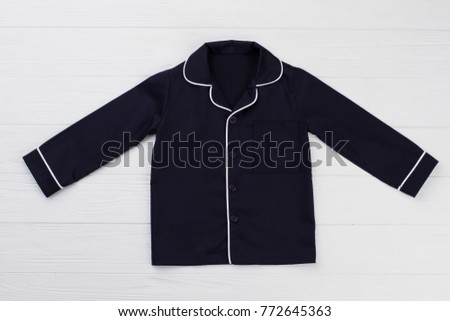 Navy shirt with rounded collar on white background. Classic style boys clothing. Perfect choice for lounging at home.