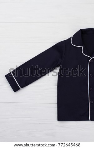 Dark blue shirt with white edging. Rounded collar. Nightwear top for comfortable child's sleep.