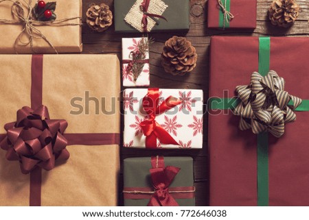 Table top shot of nicely wrapped gift boxes with Christmas lights in the foreground. Focus on the present in the middle