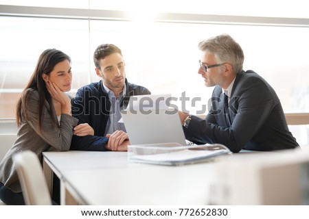 Young couple meeting financial advisor for home investment Royalty-Free Stock Photo #772652830
