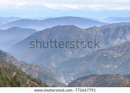 A picture of Himalayas showing endless folds of mountains creating a beautiful scenery