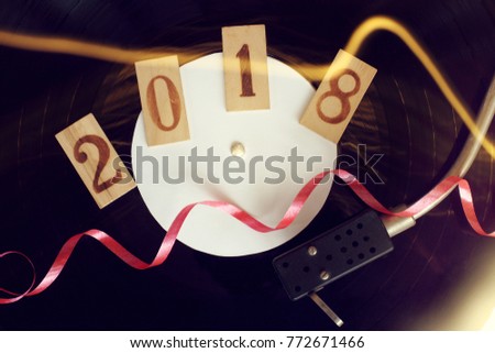 musical vinyl record in a festive setting with wooden figures / disco in retro style