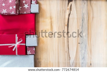 Merry Christmas and Happy New Year, winter season. Gift boxes on wood background. Flat lay with copy space for text