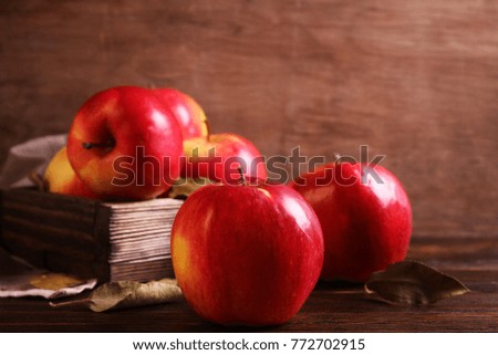 Apples in a box on a wooden table