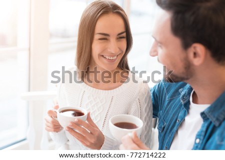 A guy and a girl are sitting together in a cafe. They drink tea, eat cakes. They are in love with each other. They are a couple.