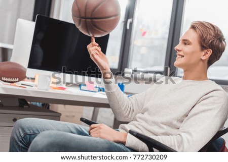 happy man spinning ball at modern office