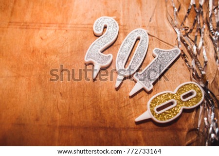 New year 2018 wood number  on wooden plank table at blur abstract  bokeh background . Merry Christmas and Happy New Year 2018 decorations . 2018 Happy new year. Gold Numbers Design of greeting card. G