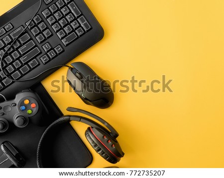 gamer workspace concept, top view a gaming gear, mouse, keyboard, joystick, headset, on yellow table background with copy space Royalty-Free Stock Photo #772735207