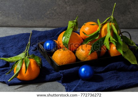 Tangerines, clementines with leaves. Dark,gray background. 
