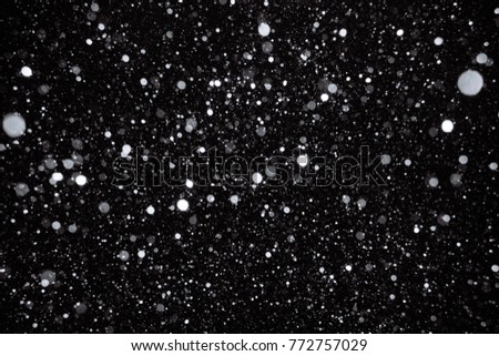 Real snow on black background