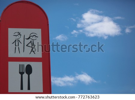 Bathroom and restaurant sign and blue sky with copy space