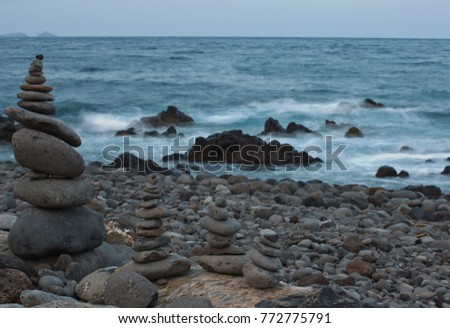 Meditation stone pyramid relaxing in front waves