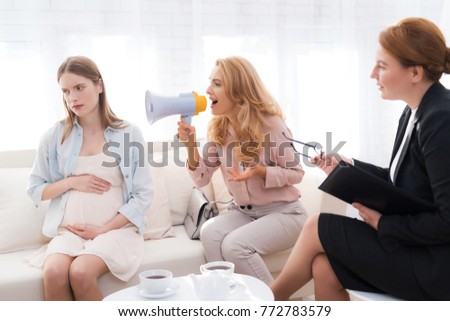 Mom with a pregnant teenage girl at a psychologist's reception. Mom and daughter have a complicated relationship. An adult woman screaming at her daughter.