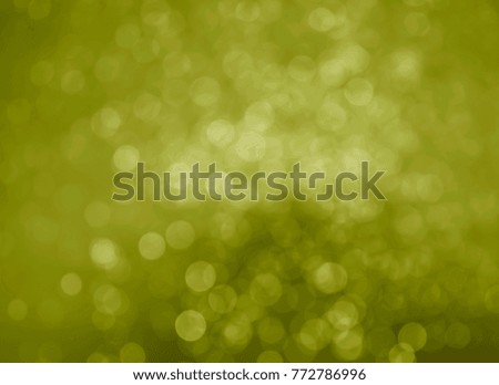 Gold bokeh on black background caused by spray water.