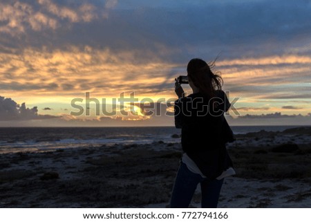 Young Woman Taking Photos of Magnificent Sunset View