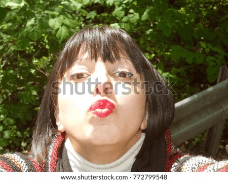 Woman take selfie with phone - sending kiss